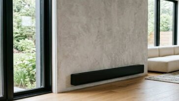A electric baseboard heater installed in a living room showing clean electric baseboard heaters properly for better efficiency and home safety.