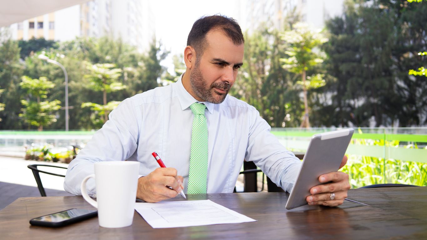 Professional reviewing financial documents on a tablet