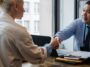Professionals discussing contract for gratuity in UAE