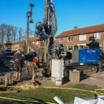 Heavy industrial water well drilling rig working on a residential property
