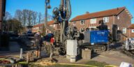 Heavy industrial water well drilling rig working on a residential property