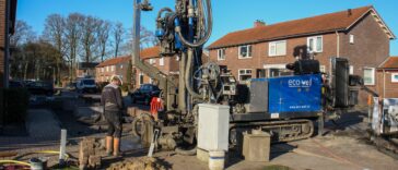 Heavy industrial water well drilling rig working on a residential property