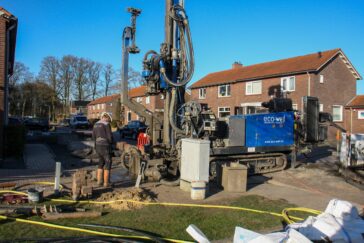Heavy industrial water well drilling rig working on a residential property