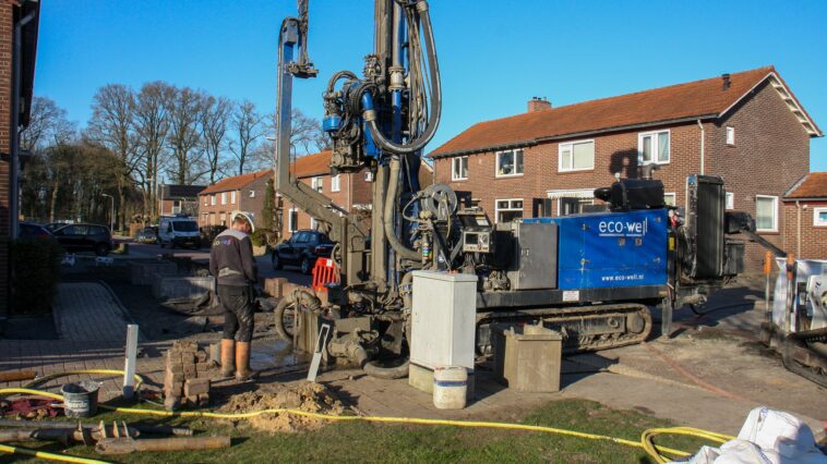 Heavy industrial water well drilling rig working on a residential property