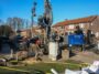 Heavy industrial water well drilling rig working on a residential property
