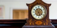 Antique wooden mantle clock showing how to wind a clock