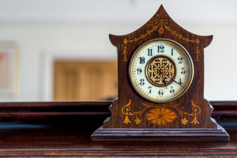 Antique wooden mantle clock showing how to wind a clock