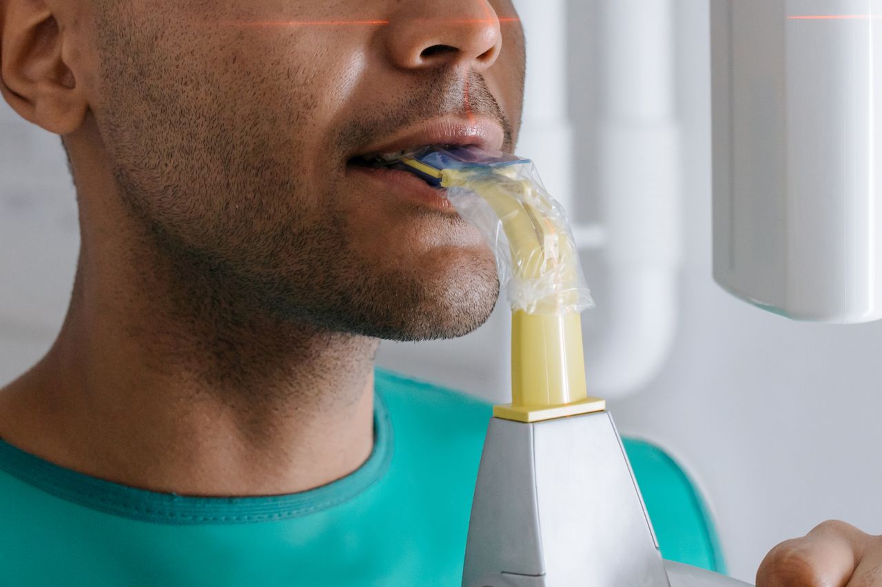 Dentist using a digital intraoral scanner on a patient
