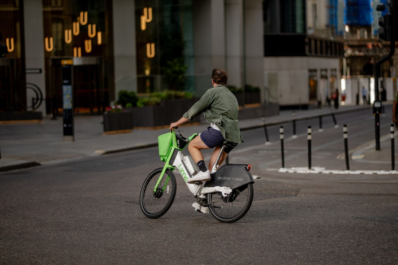 Cyclist riding an e-bike in a city bike lane