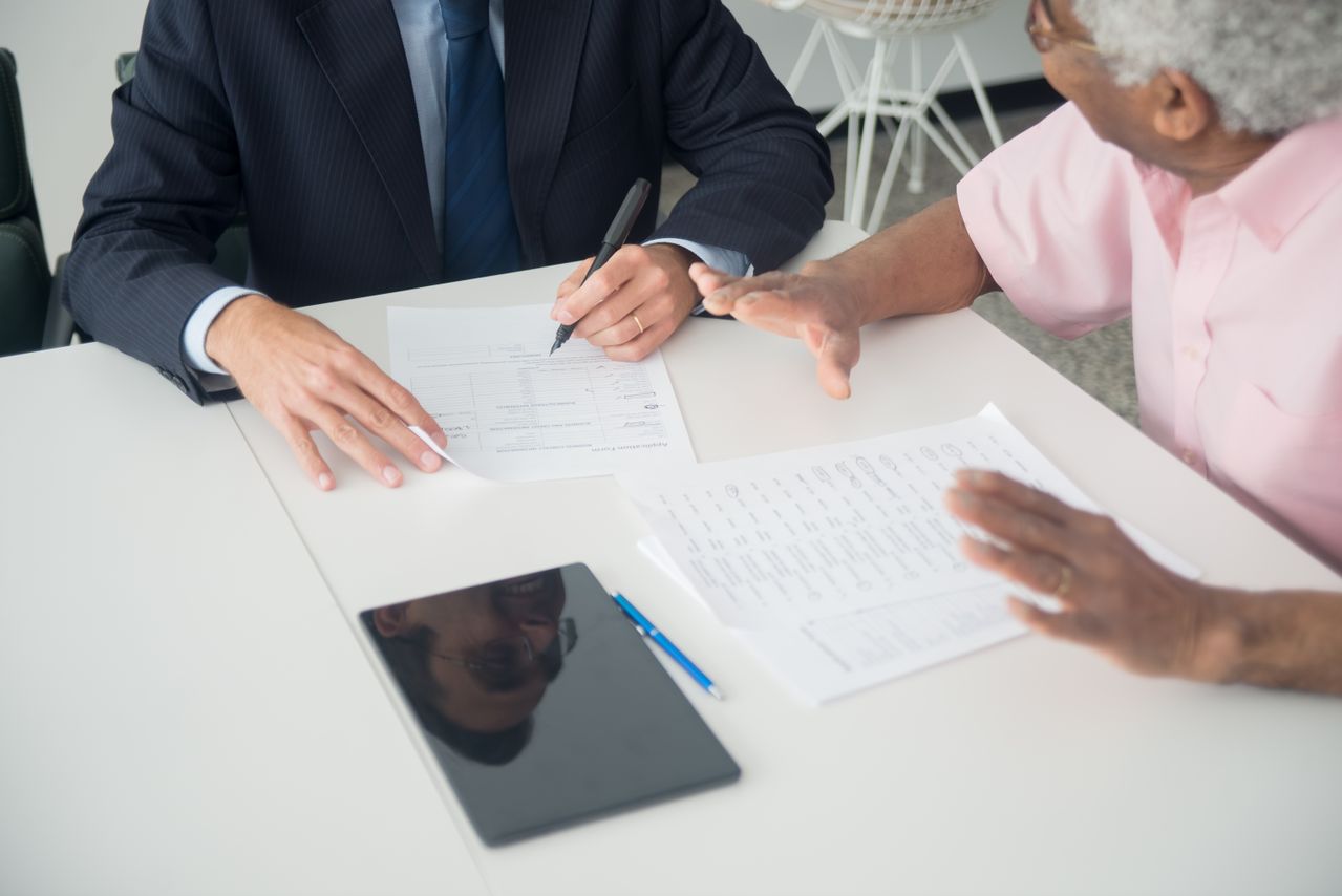Advisor reviewing legal documents with a client.