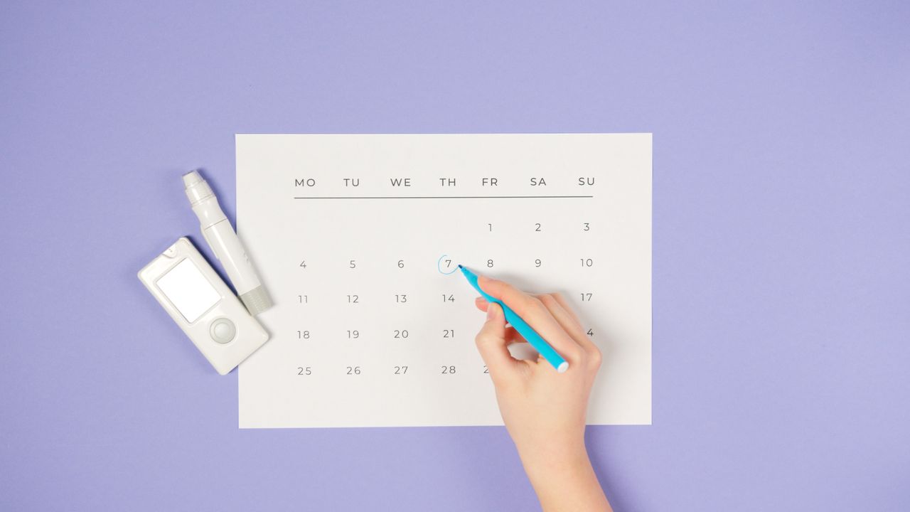 a person marking on a calendar