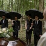 guests attending an outdoor afternoon funeral