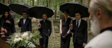 guests attending an outdoor afternoon funeral