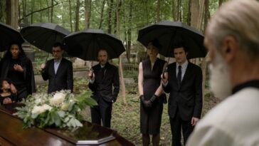 guests attending an outdoor afternoon funeral