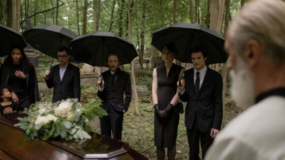 guests attending an outdoor afternoon funeral