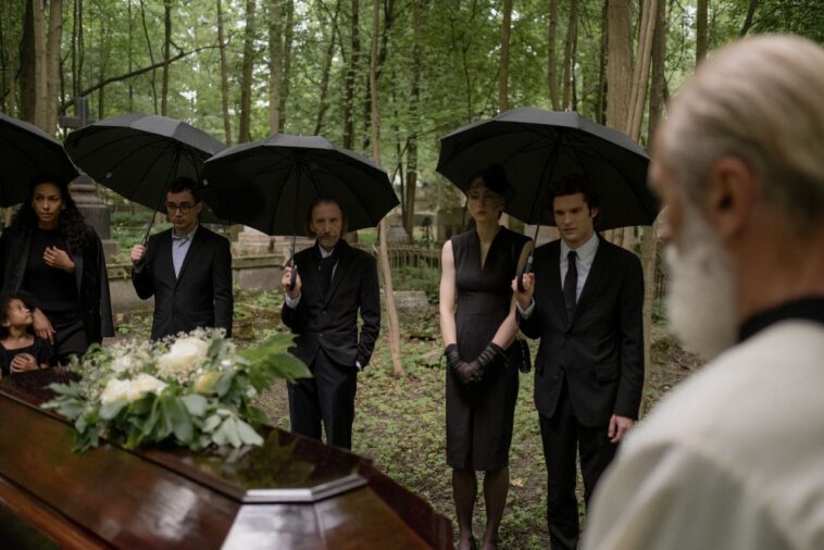 guests attending an outdoor afternoon funeral