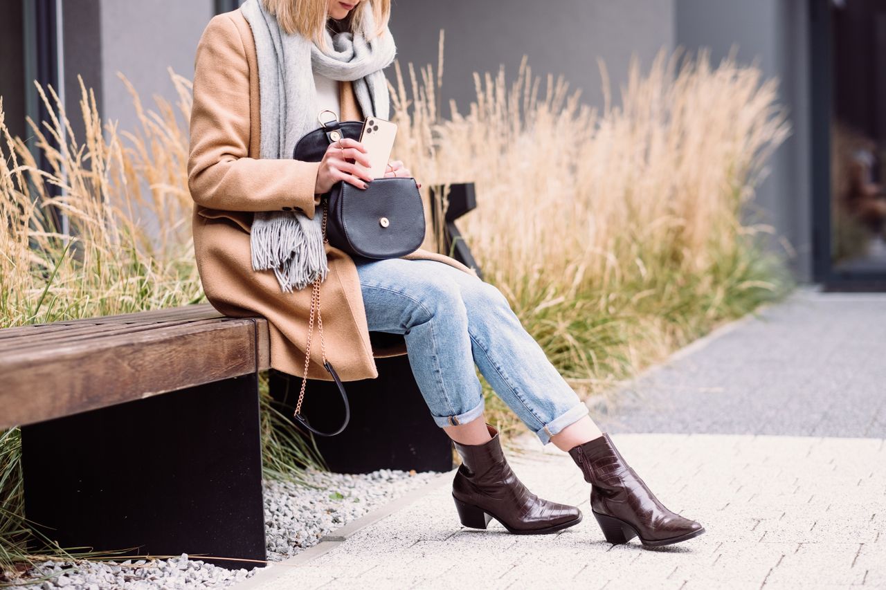 Periwinkle sweater styled with jeans, camel coat, scarf.