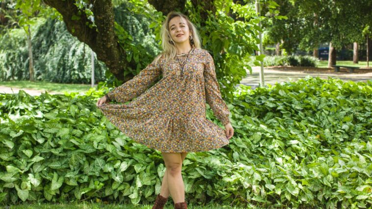 Woman wearing a floral Uncle Frank dress.