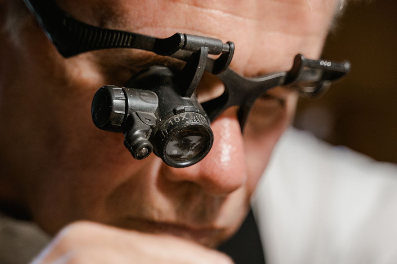 Jeweler wearing a head-mounted 10x magnifying loupe.