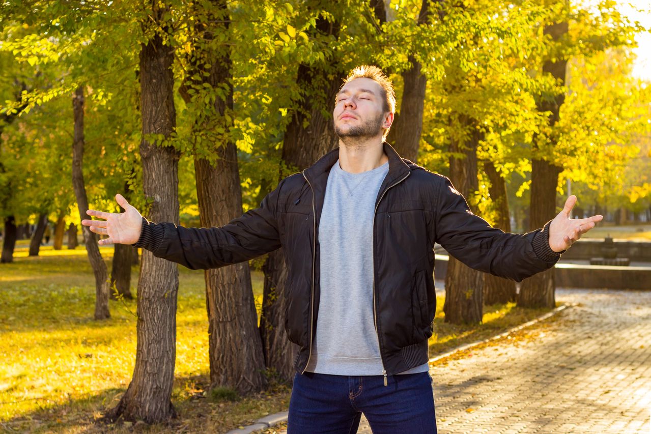 someone taking a slow breath outdoors
